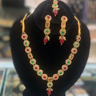 Golden necklace and earring set with green stones