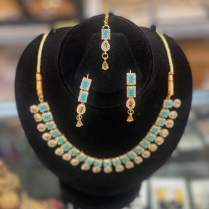 Golden necklace and earring set with green stones