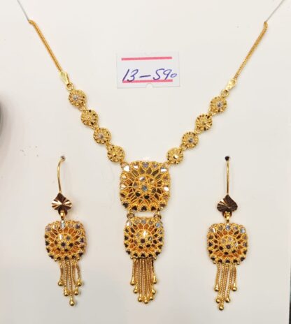 A 21K gold bridal mala set featuring a square lattice design with intricate craftsmanship, hanging tassels, and matching earrings, weighing 1 tola.