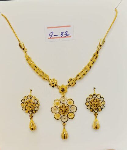 This captivating necklace and earring set features a blossoming flower design, meticulously crafted from luxurious 21k gold filigree