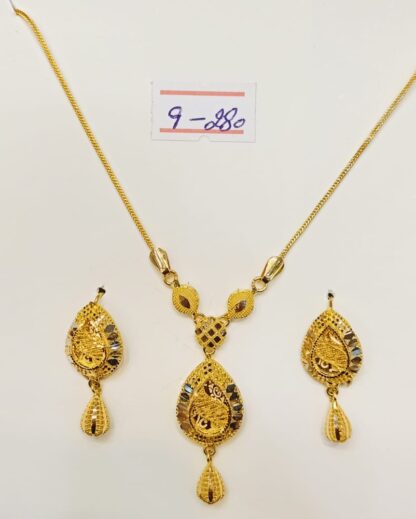 This captivating necklace and earring set features a swirling paisley design, meticulously crafted from luxurious 21k gold.