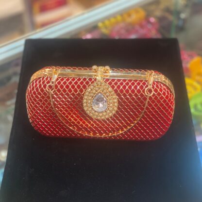 Red Clutch with a Diamond Brooch