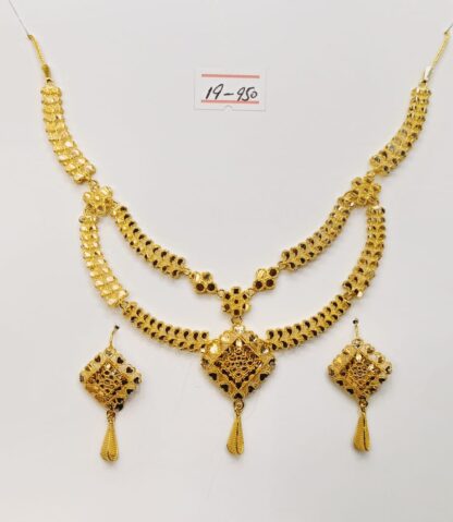 This captivating necklace and earring set features a delicate swirl design, meticulously crafted from gleaming 21ct gold.