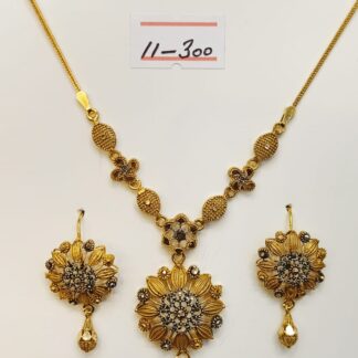 Indulge in timeless elegance with this meticulously crafted 21k gold necklace and earring set, featuring a captivating floral design.