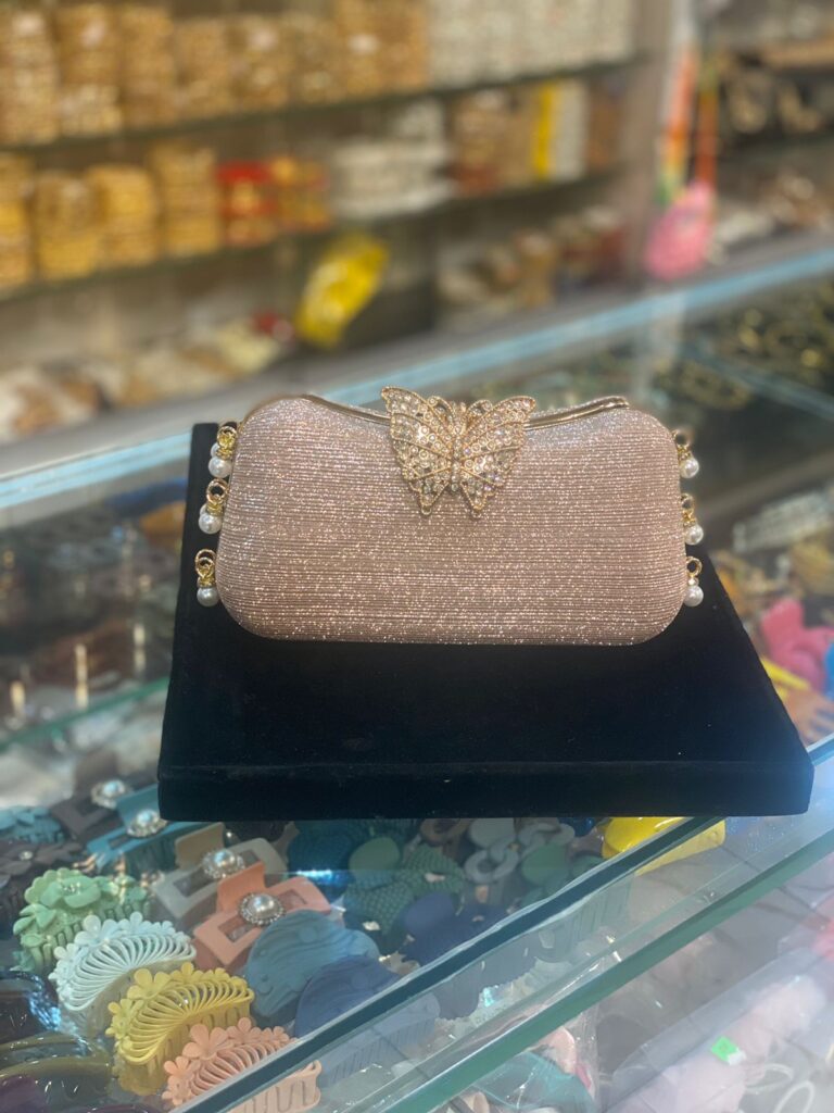 Shimmer like a butterfly bride with this elegant golden clutch adorned with pearls and crystals.