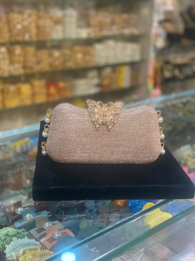 Shimmer like a butterfly bride with this elegant golden clutch adorned with pearls and crystals.