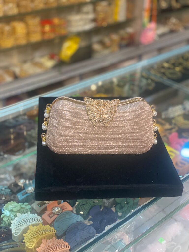 Shimmer like a butterfly bride with this elegant golden clutch adorned with pearls and crystals.