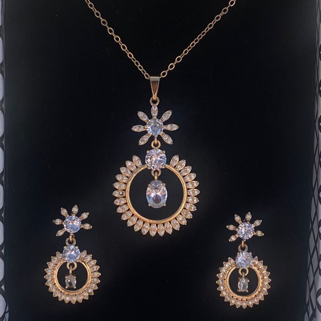 This pear-shaped pendant set shimmers with a moonstone center and dazzling cubic zirconia accents.