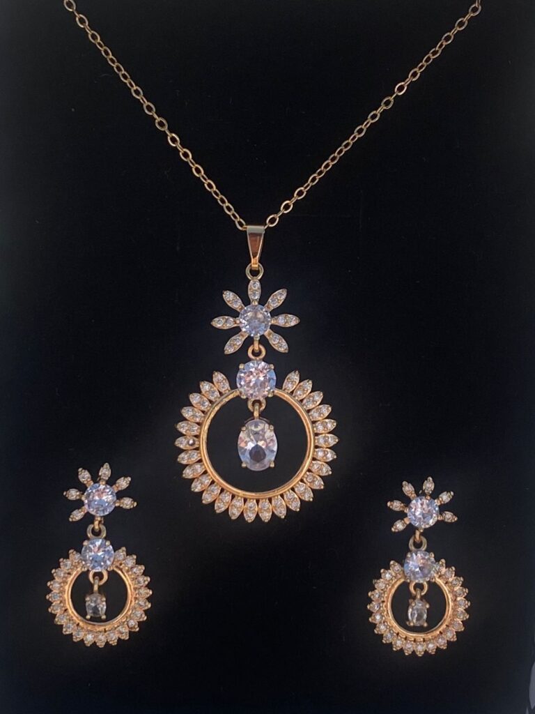 This pear-shaped pendant set shimmers with a moonstone center and dazzling cubic zirconia accents.