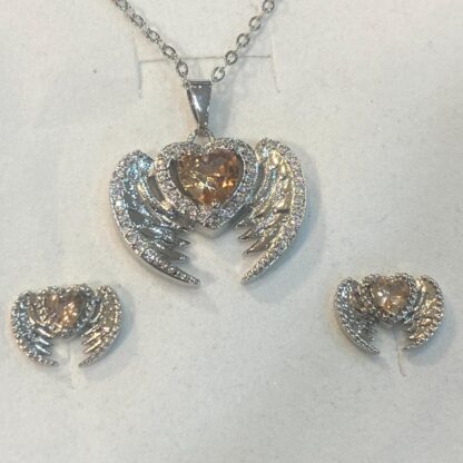 Find faith and style with this silver-plated angel wing necklace and earring set.