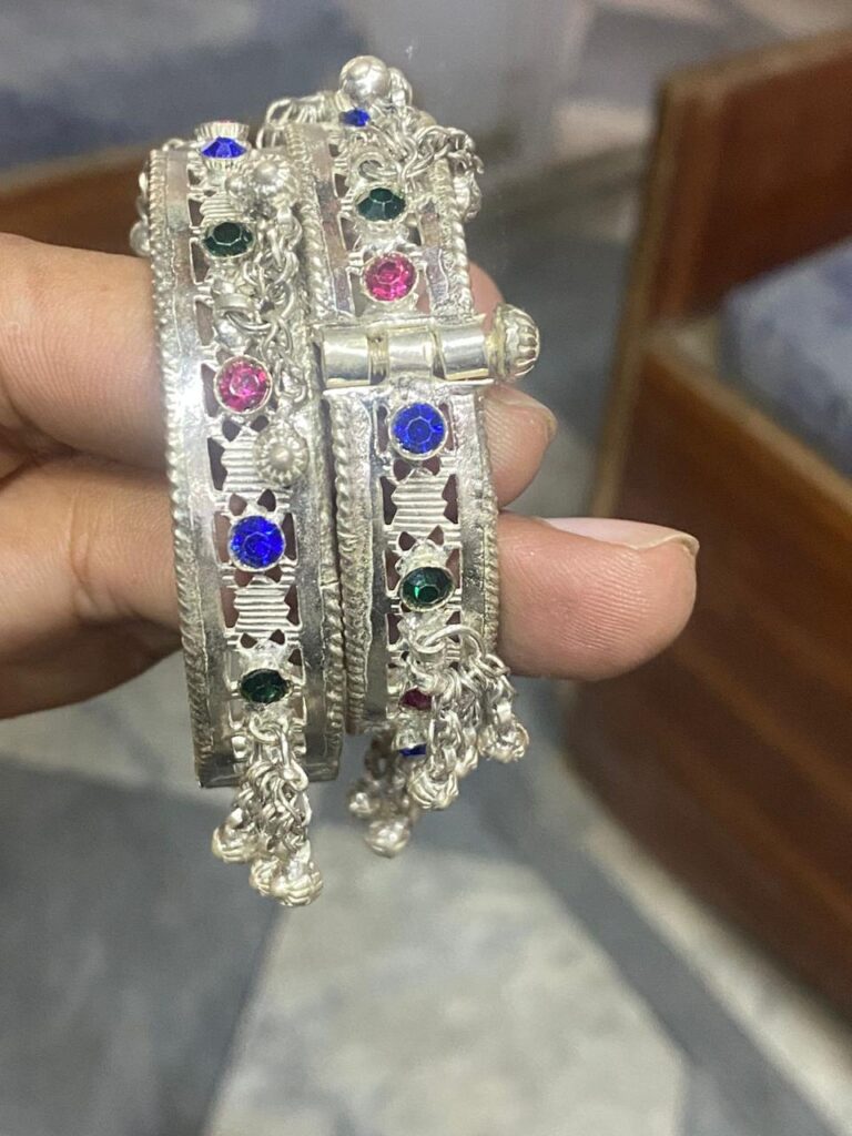 Channel the glamour of the roaring twenties with these art deco-inspired sterling silver bangles featuring vibrant gemstones.