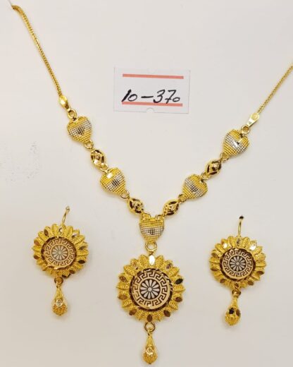 Elevate your look with this luxurious 21K gold necklace and earring set. The necklace features a stunning pendant adorned with a Versace-inspired pattern, exuding timeless elegance.