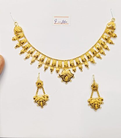 This elegant gold necklace and earring set features a curved leaf design with a polished finish.