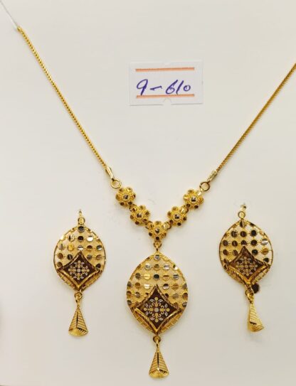 This 21K gold necklace and earring set features a mesmerizing lacework design, adding a touch of intricate elegance to any outfit.