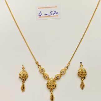 This 21K gold necklace and earring set features a mesmerizing interlocking circles design, symbolizing infinity and everlasting connections.