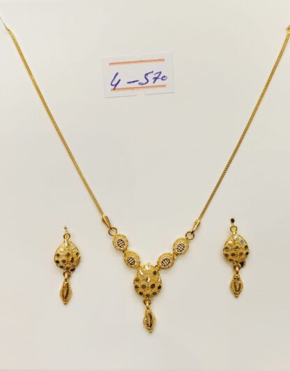 This 21K gold necklace and earring set features a mesmerizing interlocking circles design, symbolizing infinity and everlasting connections.