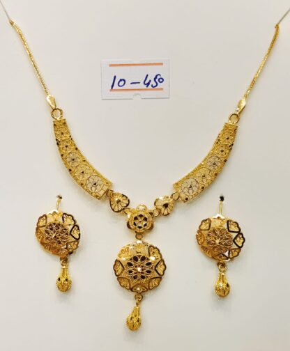 A stunning 21k gold necklace and earring set, showcasing intricate filigree work and traditional jhumki-inspired accents. Perfect for special occasions or as a timeless heirloom.