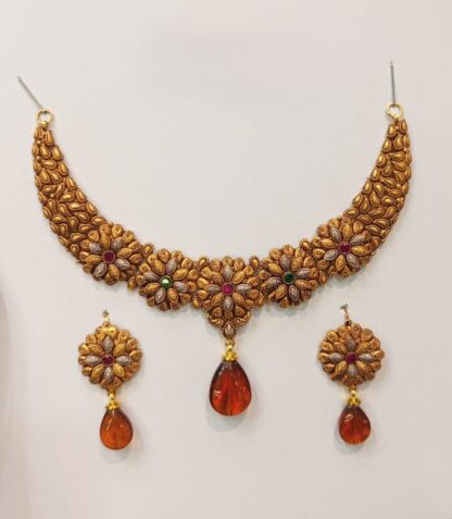 An exquisite 21K gold Madrasi choker necklace set adorned with vibrant multicolored stones and amber teardrop pendants, paired with matching earrings.