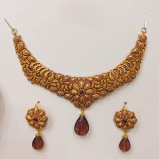 A gracefully designed 21K gold Madrasi choker necklace set with intricate patterns and brown teardrop pendants, complemented by matching earrings.