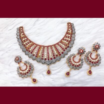 Elegant red and silver Chand Bali necklace set with ruby gemstones and intricate silver floral detailing.