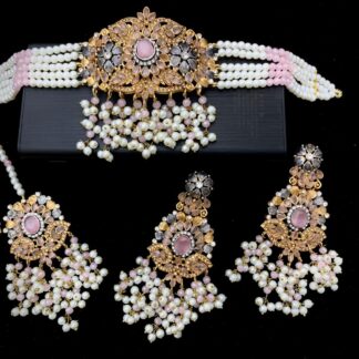 Handcrafted pink Kundan choker necklace set with pearl bead strands, matching jhumka earrings, and maang tikka – bridal jewelry by Carat Vogue