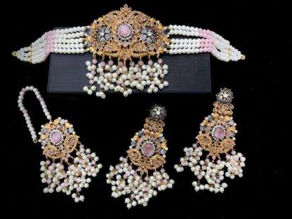 Handcrafted pink Kundan choker necklace set with pearl bead strands, matching jhumka earrings, and maang tikka – bridal jewelry by Carat Vogue