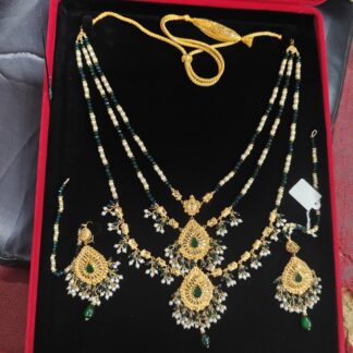 2 Tola Bridal 21K gold necklace set with green beads, filigree pendant, pearl drops, and matching earrings in red velvet box.