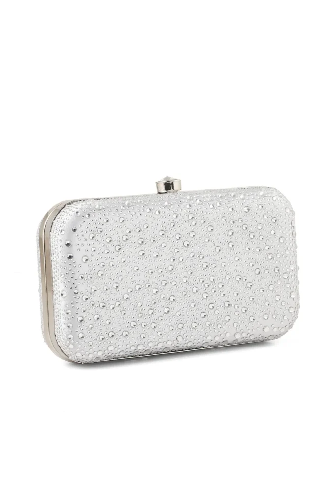 A structured, elegant silver clutch can provide a sophisticated contrast to a sleek, minimalist dress, adding a touch of sparkle and refinement.