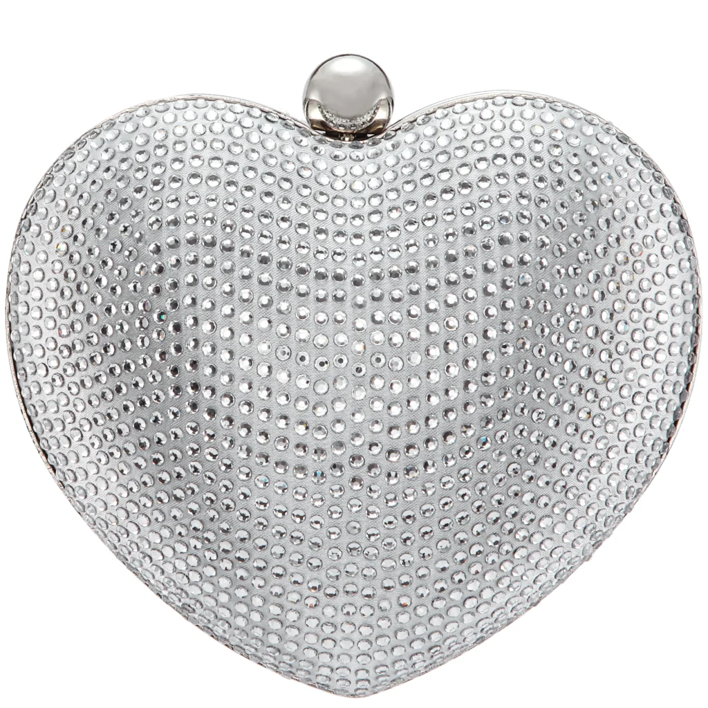 Silver heart-shaped evening clutch with a metallic finish, featuring a crystal-studded surface and a removable chain strap for crossbody or hand carry.