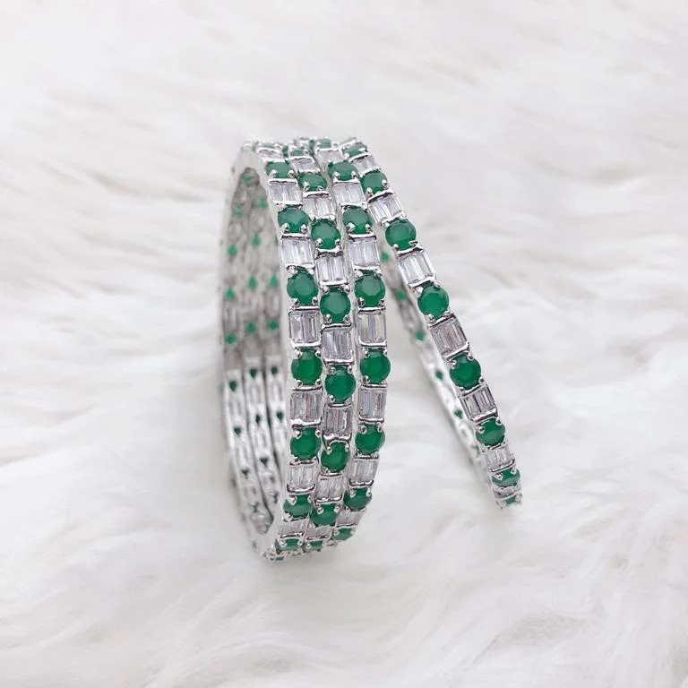Luxury Silver Plated AD Stone Bangle Set with Emerald Green Highlights Luxury Silver Plated AD Stone Bangle Set with Emerald Green Highlights featuring American Diamond and Emerald Green stones by Carat Vogue