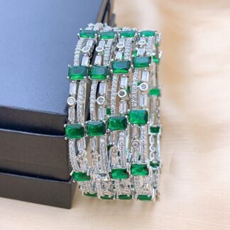 Luxury Silver Plated AD Stone Bangle Set with Emerald Green Highlights Luxury Silver Plated AD Stone Bangle Set with Emerald Green Highlights featuring American Diamond and Emerald Green stones by Carat Vogue
