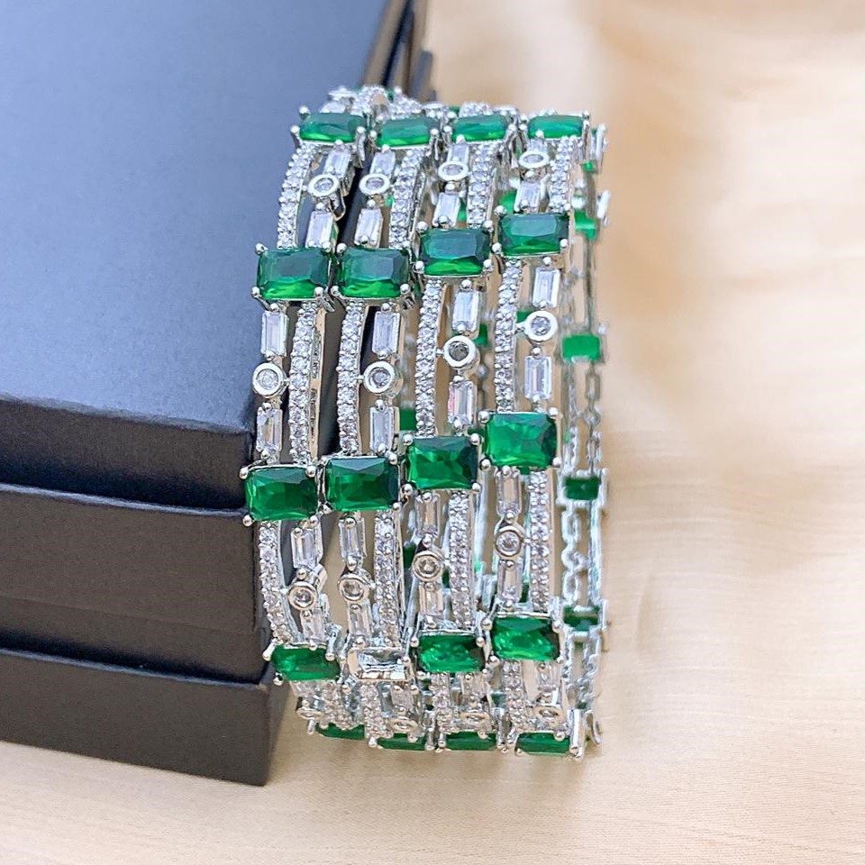 Luxury Silver Plated AD Stone Bangle Set with Emerald Green Highlights Luxury Silver Plated AD Stone Bangle Set with Emerald Green Highlights featuring American Diamond and Emerald Green stones by Carat Vogue