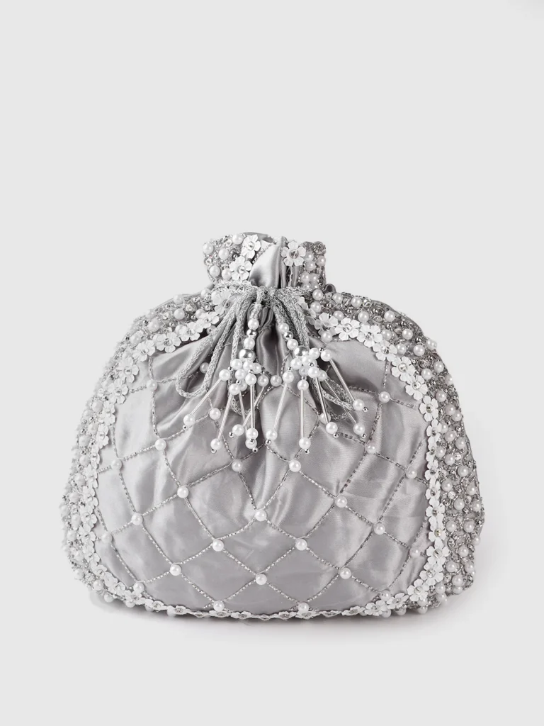 Silver potli bag with intricate embroidery and pearl handle.