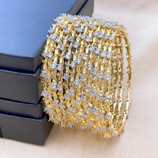 Homepage 9 Twelve ultra-slim bangles in alternating finishes, each dotted with tiny AD stones. Designed for stacking, mixing, and matching—ideal for festive layering.