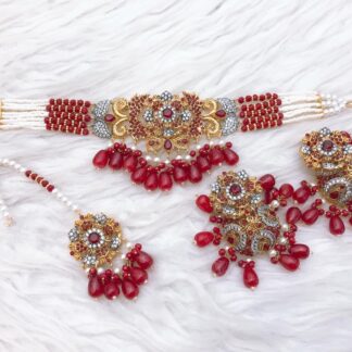 Ruby, emerald, and white stone choker set with gold finish, featuring American diamonds, matching earrings, and maang tikka – Carat Vogue bridal jewelry Pakistan