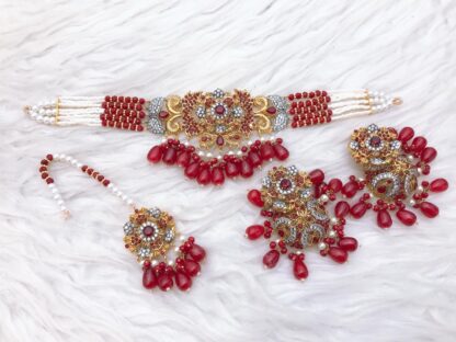 Ruby, emerald, and white stone choker set with gold finish, featuring American diamonds, matching earrings, and maang tikka – Carat Vogue bridal jewelry Pakistan