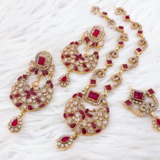 Shop our Traditional Ruby Red & Gold Jewelry Set. Includes Chandbali necklace, large drop earrings, and maang tikka. Perfect for weddings and festive wear.