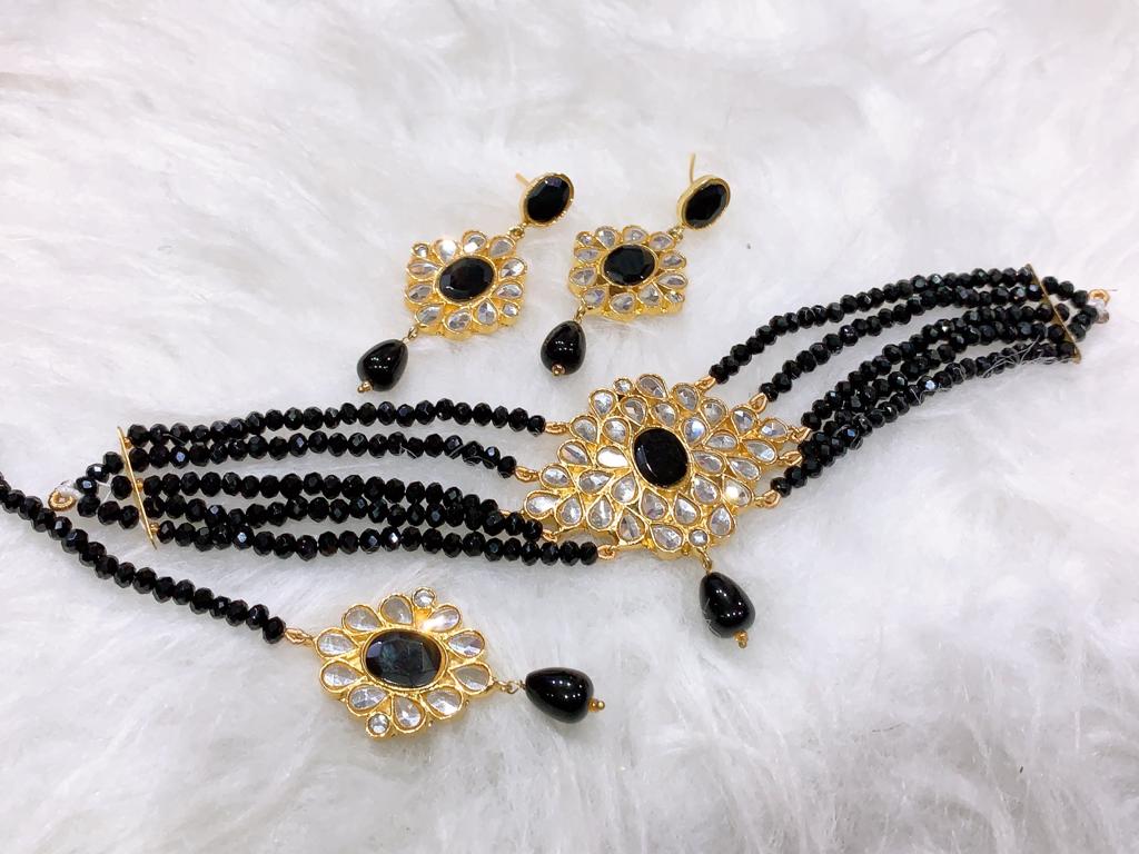 Black Onyx Bead Kundan Choker Set Traditional 4-strand black onyx bead choker with a gold floral Kundan pendant and matching square earrings.
