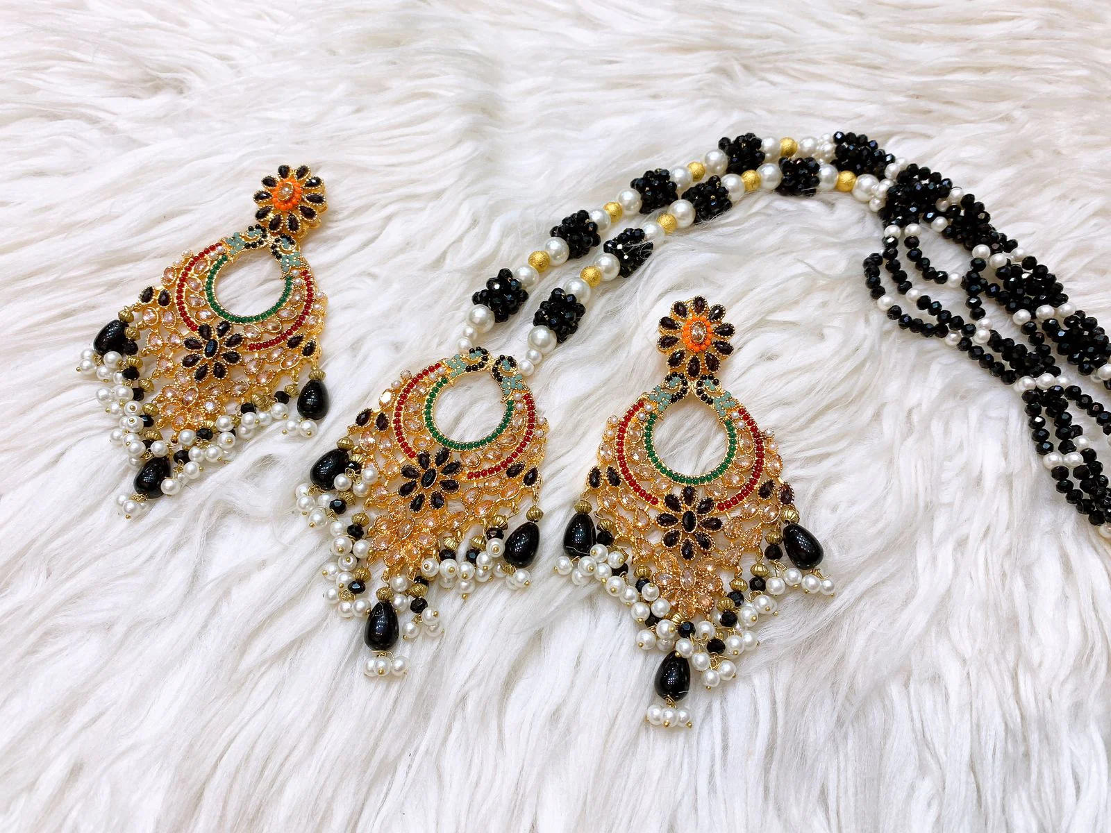 Black Onyx Floral Mala & Chandbali Earrings Ses Traditional long Black Onyx bead Mala with grand gold-toned Chandbali earrings and floral enamel pendant.