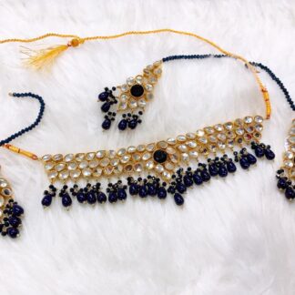 Luxurious Royal Blue Onyx Kundan Choker necklace set with teardrop kundan stones and matching earrings for bridal wear.