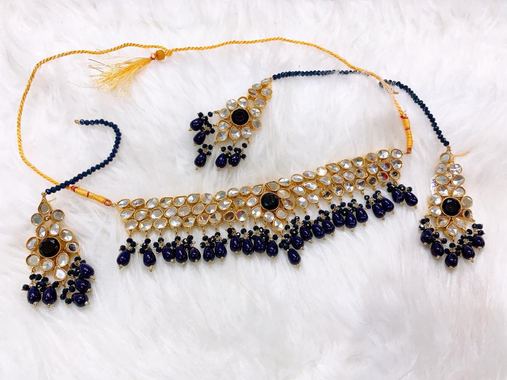 Blue Onyx Kundan Choker Set Luxurious Royal Blue Onyx Kundan Choker necklace set with teardrop kundan stones and matching earrings for bridal wear.