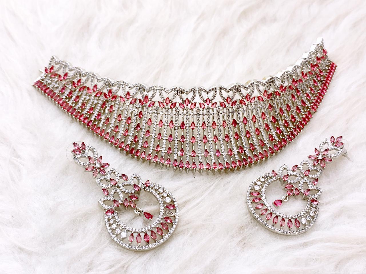 Lustrous Red & White American Diamond Bridal Wedding Choker Set — Royal Heritage Edition High-shine silver bridal wedding choker featuring white American Diamonds and marquise-cut ruby red stones in a cascading heart-pattern design.