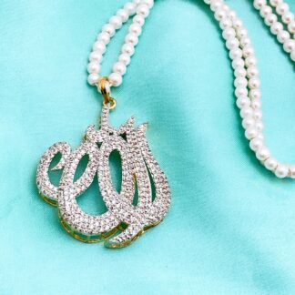 Diamond-encrusted silver Allah calligraphy pendant on a double-strand white pearl necklace, displayed on a light blue background.