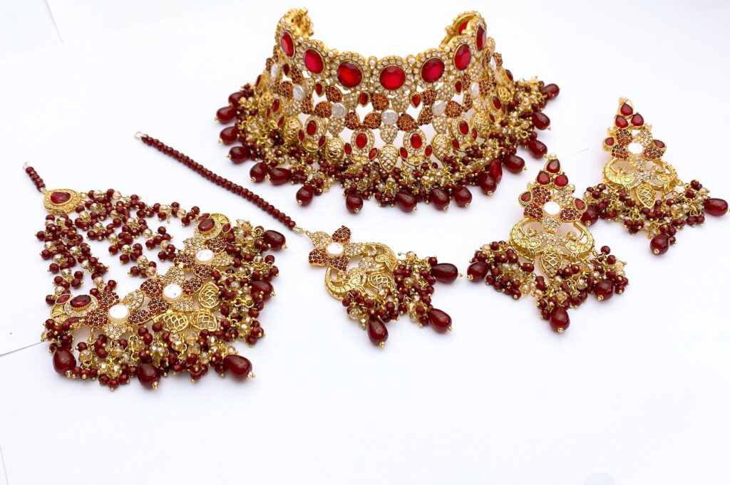 Handcrafted emerald green artificial necklace set with 22k gold plating for Pakistani brides.