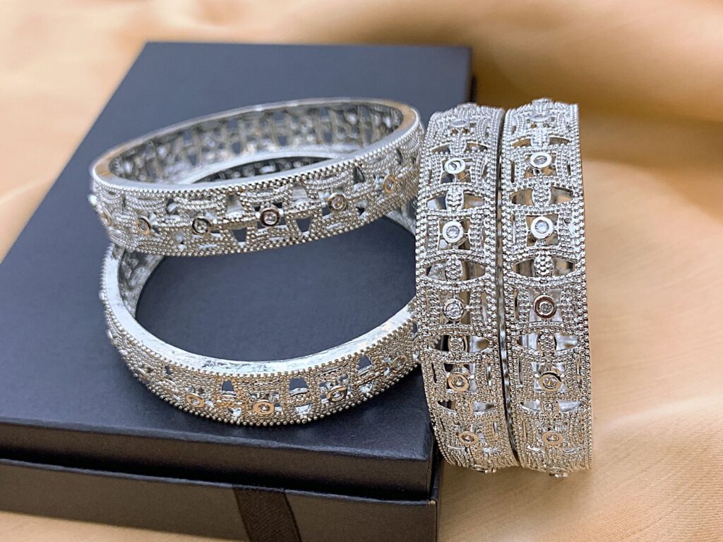 Classic gold plated American Diamond bangles set featuring clear brilliant stones in a minimalist design. Ideal for formal wear and evening styling in Germany, offering understated luxury and timeless elegance.