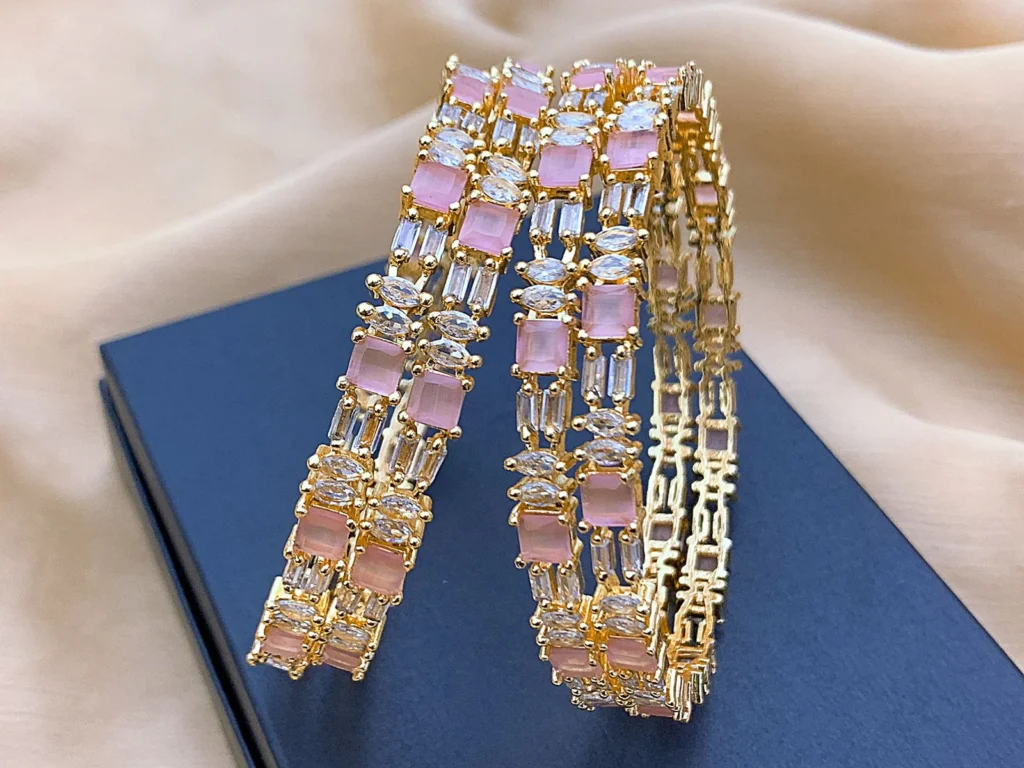 Stylish rose gold American Diamond bangles set with pink stone accents and brilliant AD sparkle. Perfect for weddings, receptions, and formal parties in the UK. Lightweight, fashionable, and easy to stack.
