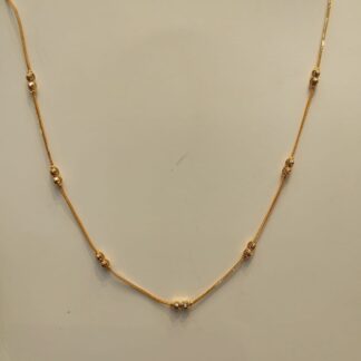 Stylish simple gold chain design for female featuring thin gold link and bead clusters.