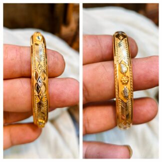 Close-up of a 7-gram 22K gold bangle with leaf filigree and two-tone white gold accents.