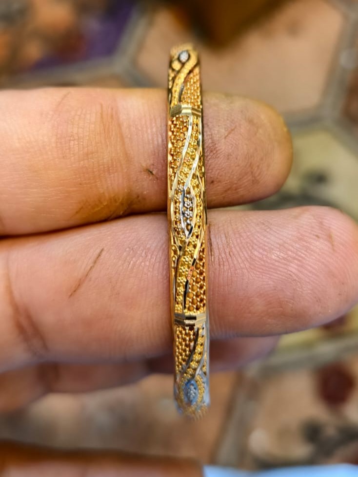 7 Grams 22K Solid Yellow Gold Bangle (916 Purity) Traditional 22Kt gold kara bangle weighing 7 grams showcasing an intricate wave pattern with textured sandblast granular details and delicate silver rhodium-toned diamond-cut accents.