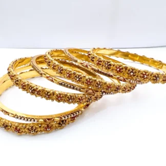 Set of seven premium 22ct gold-plated 1-gram bridal chooriyan bangles featuring raised antique floral medallions, maroon enamel accents, and textured micro-beaded borders.